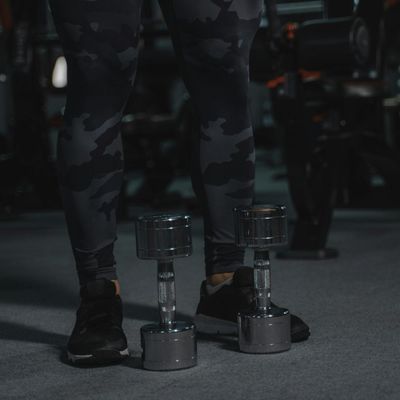 Close-up of comfortable sports shoes on a dark floor.