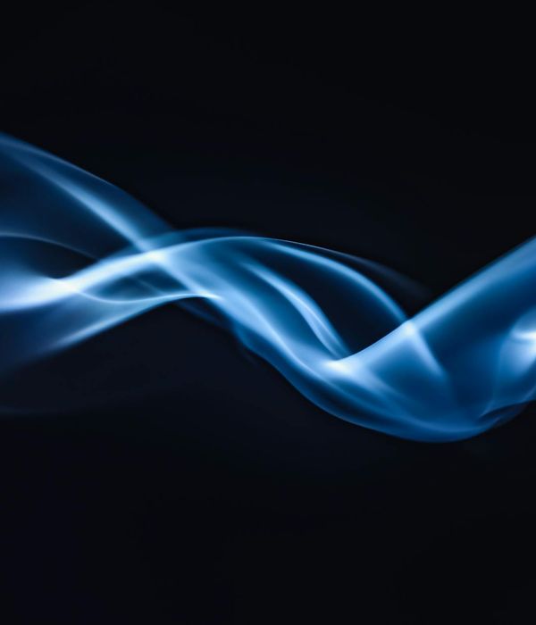 Silhouette of a person in a dynamic, flowing movement against a dark, calm background.